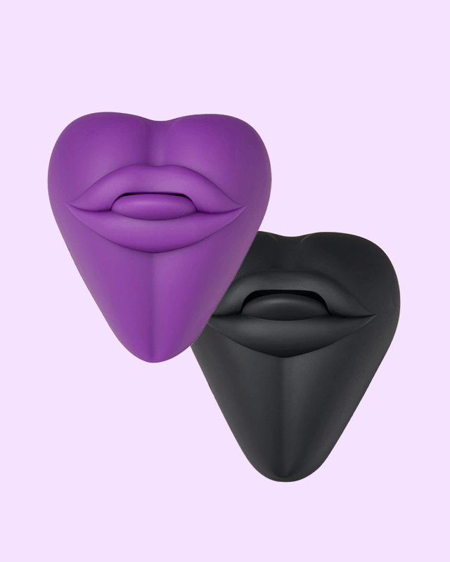 Purple and black lip-shaped Kissi cushion dildo base covers on a light purple background