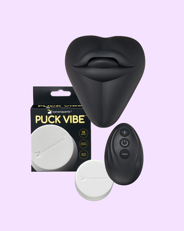 Black Kissi dildo cover and Puck Vibe with Remote Control Bundle in its packaging on a light purple background